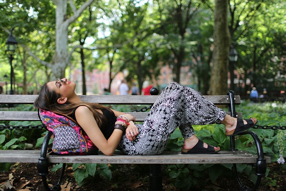 Girl On Bench With Backpack