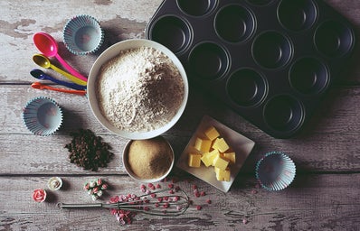 baking ingredients on a table next to a cupcake tray