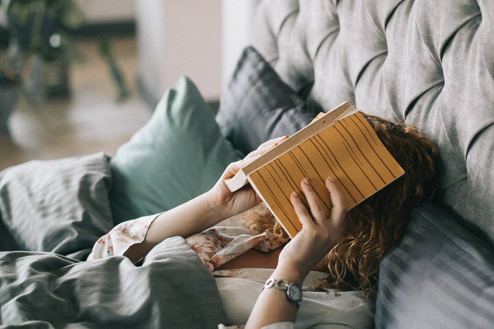 Woman Covering Face With Book On Bed 1524232?width=698&height=466&fit=crop&auto=webp