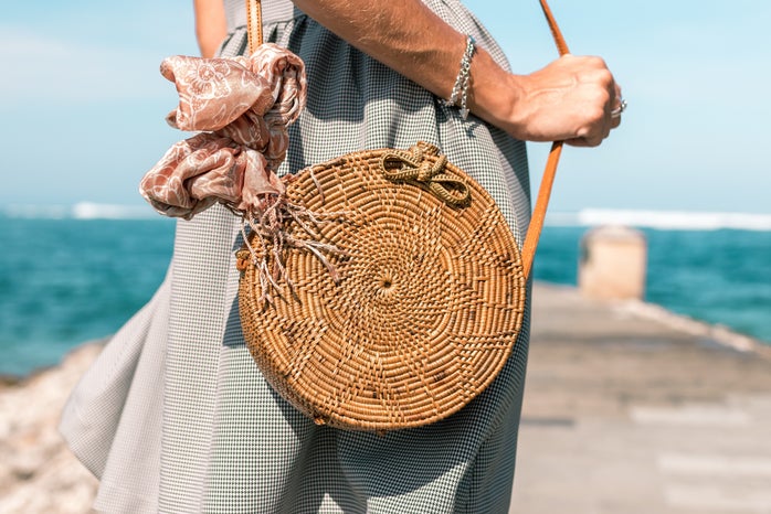 Woman Wearing Grey Skirt And Round Brown Rattan Crossbody 1102225?width=698&height=466&fit=crop&auto=webp