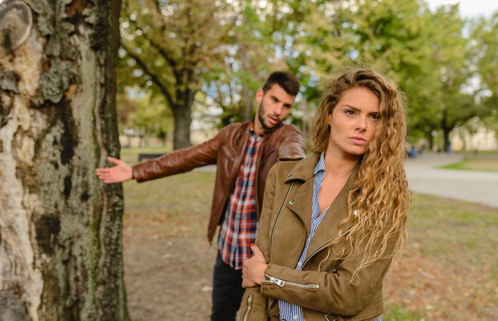Woman And Man Wearing Brown Jackets Standing Near Tree