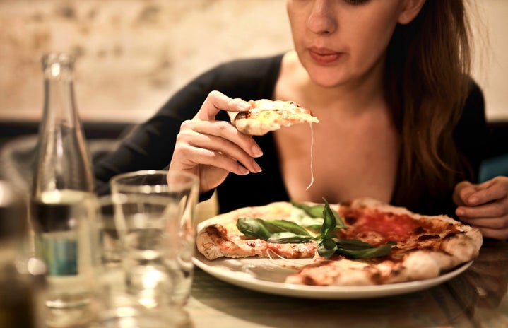 Woman Holds Sliced Pizza Seats By Table With Glass 723031?width=719&height=464&fit=crop&auto=webp
