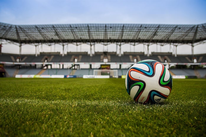 soccer ball at empty soccer stadium