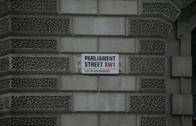 gray building with white Parliament Street signage photo
