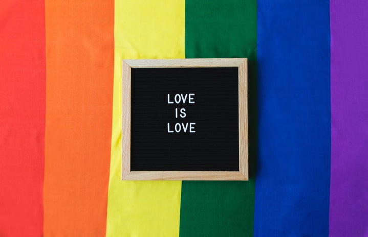 Love is Love board on Pride Flag