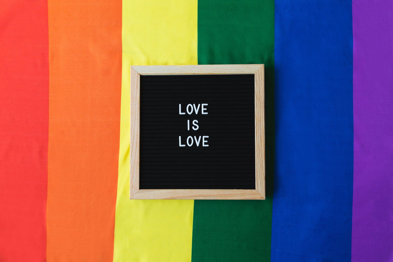 Love is Love board on Pride Flag