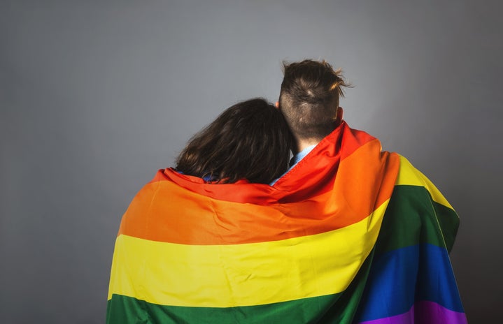 couple wrapped in Pride flag