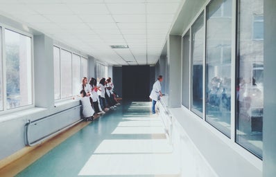 There are doctors standing in the hallway of a hospital.