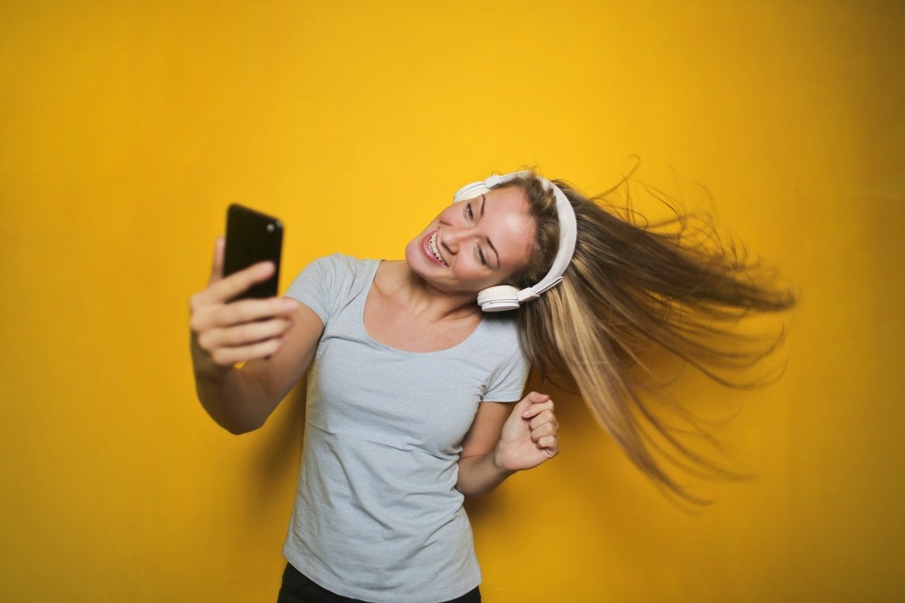 Woman with headphones listening to music