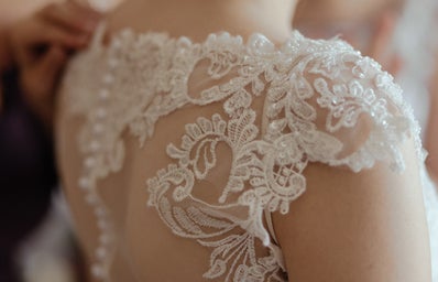 close up of a woman's shoulders in a wedding dress