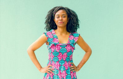 person in colorful dress against green backdrop
