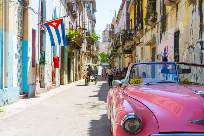 old fashioned pink convertible car in Cuba
