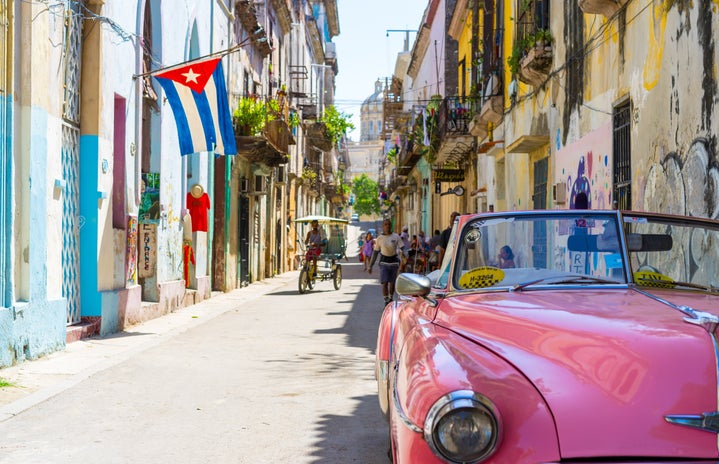 old fashioned pink convertible car in Cuba