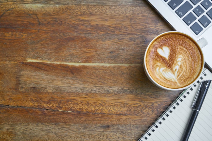 wooden background with laptop and coffee