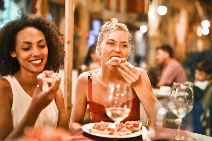 Women eating bruschetta together