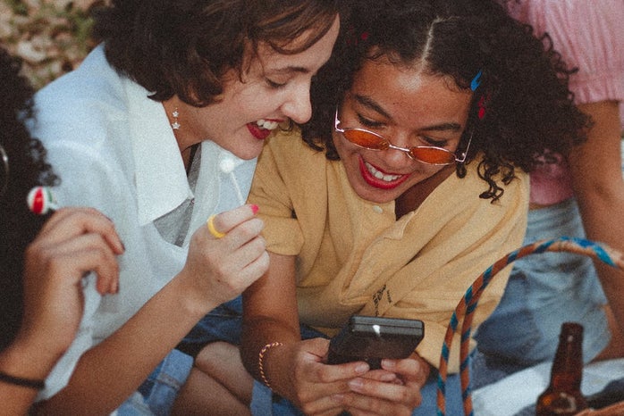 Women using gameboy together
