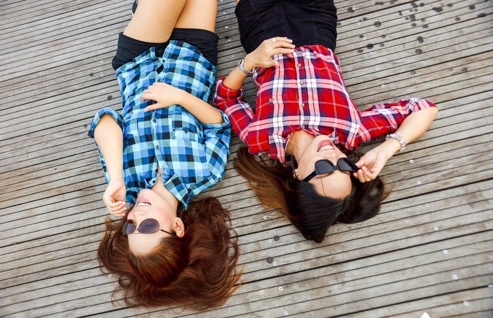 2 women laying on a deck in flannel