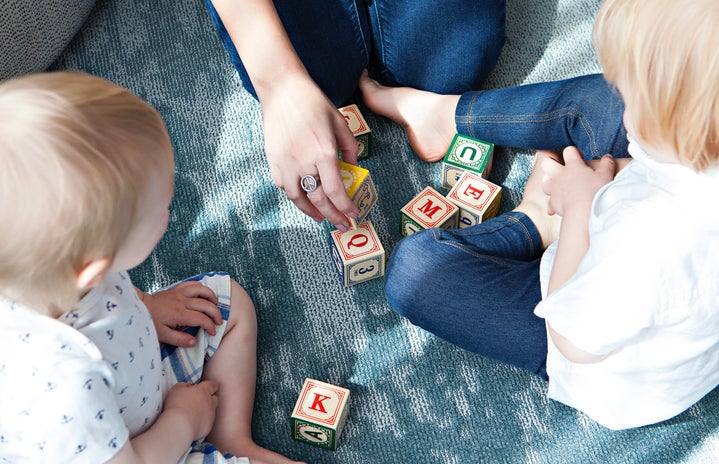 girls play with blocks with babies