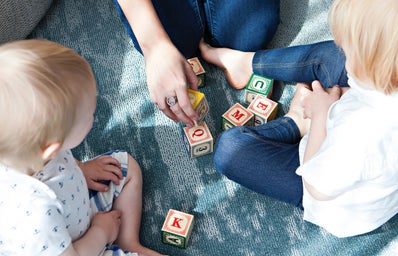 girls play with blocks with babies