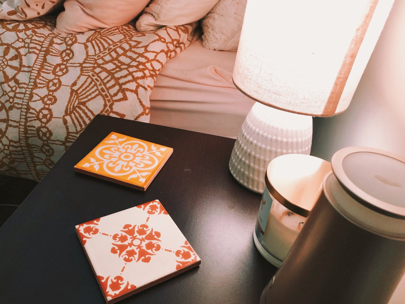 decorated night stand with lamp and tiles