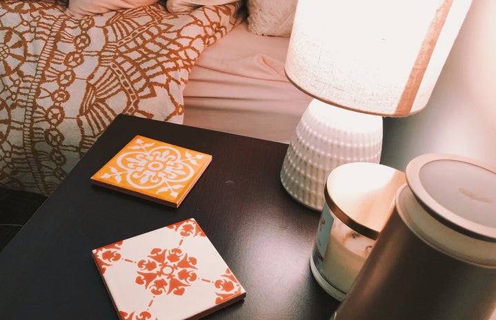 decorated night stand with lamp and tiles
