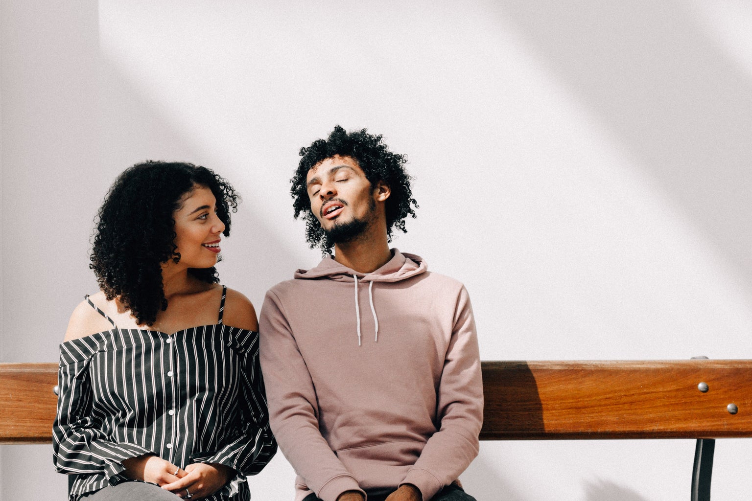 man and woman sitting on a bench