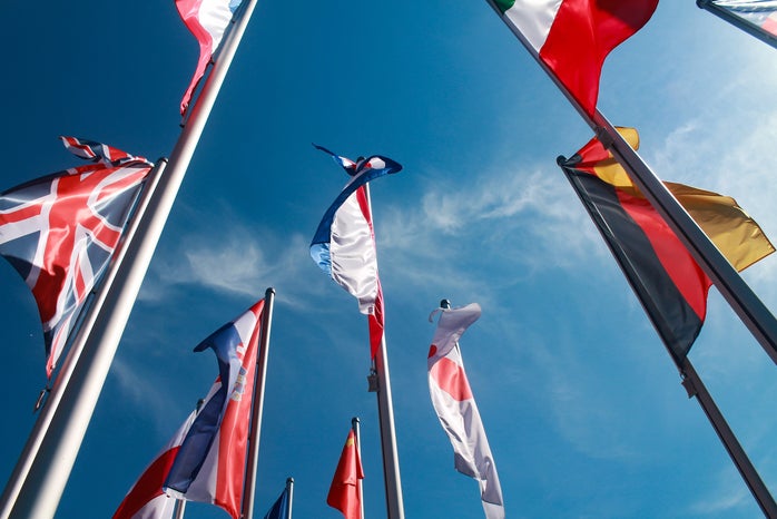 assorted nations flags against the sky?width=698&height=466&fit=crop&auto=webp