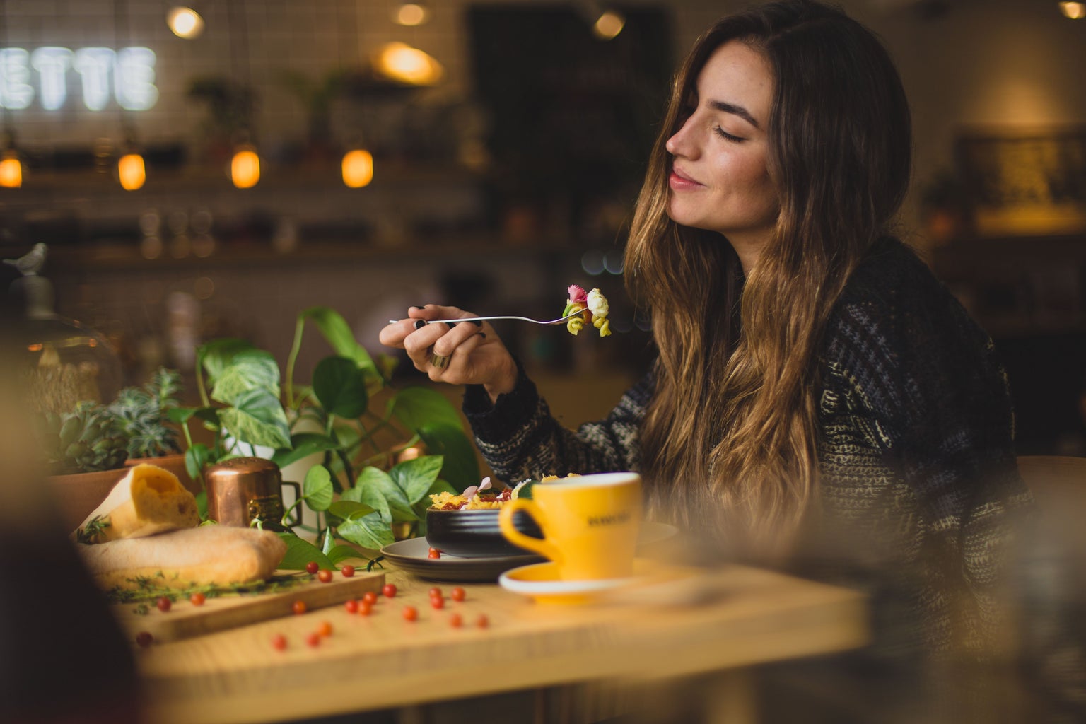 woman eating at a restaurant table