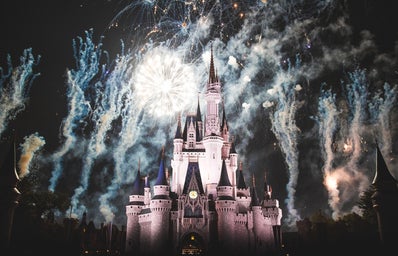 Disneyland's Sleeping Beauty Castle amid a nighttime fireworks show