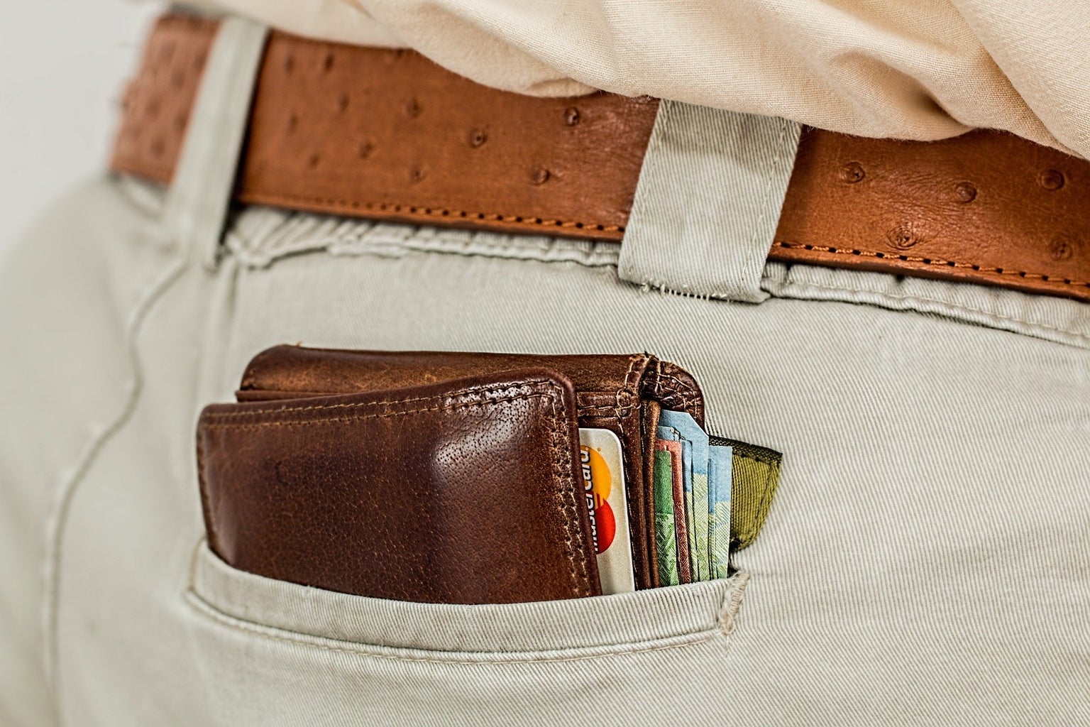 wallet peaking out back pocket with credit cards