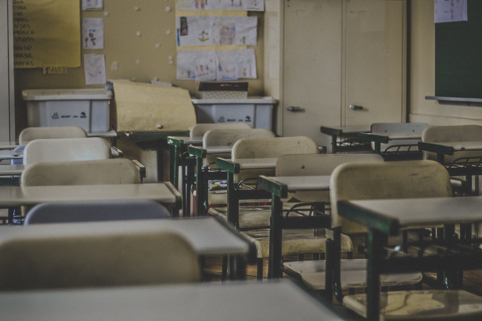 empty classroom with wooden chairs and desks