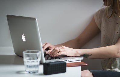 women typing on a laptop