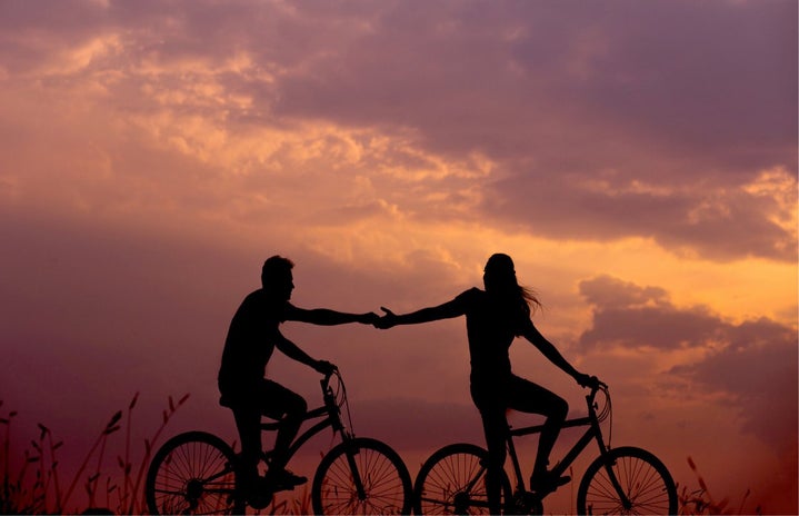 man and woman on bikes at sunset