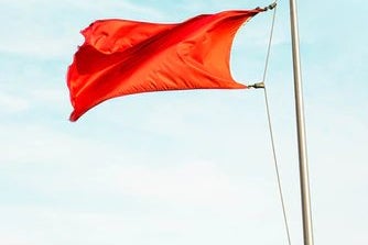 Red flag flying in wind