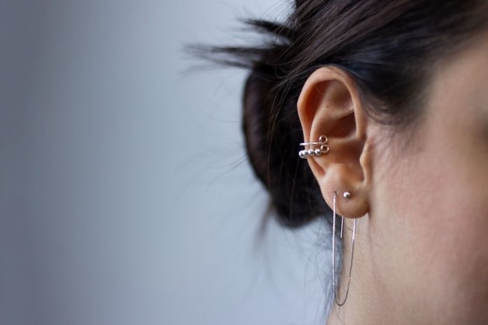 Silver ear piercing in ear