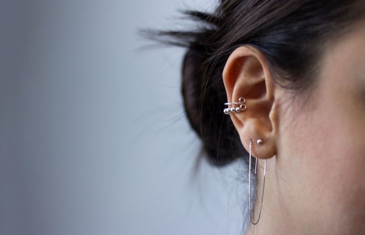 Silver ear piercing in ear