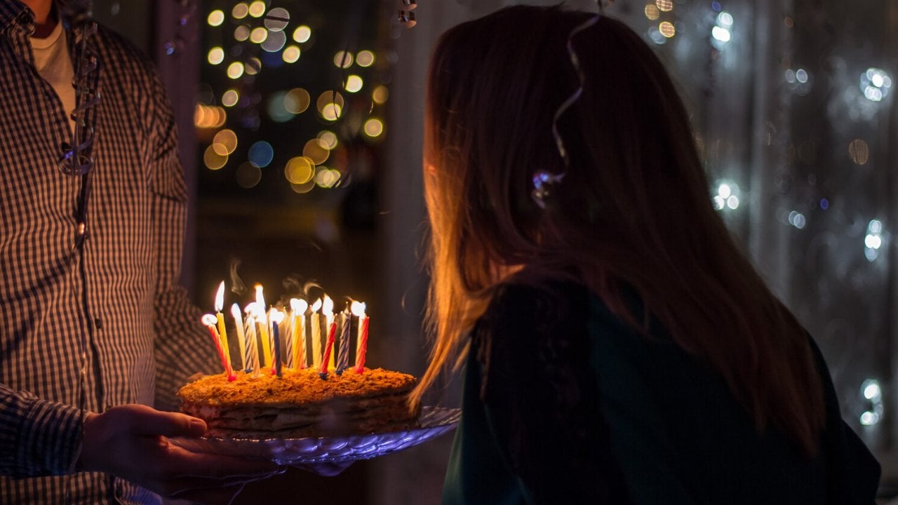 Girl blowing out candles