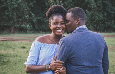 A black couple poses for the camera smiling