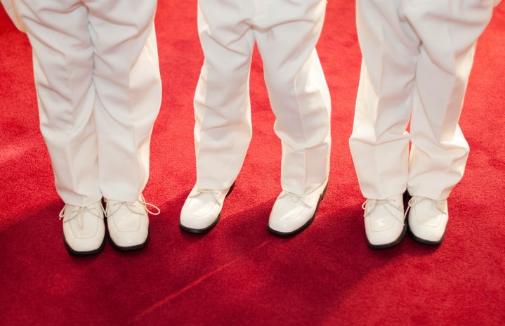 three boys standing on red carpet