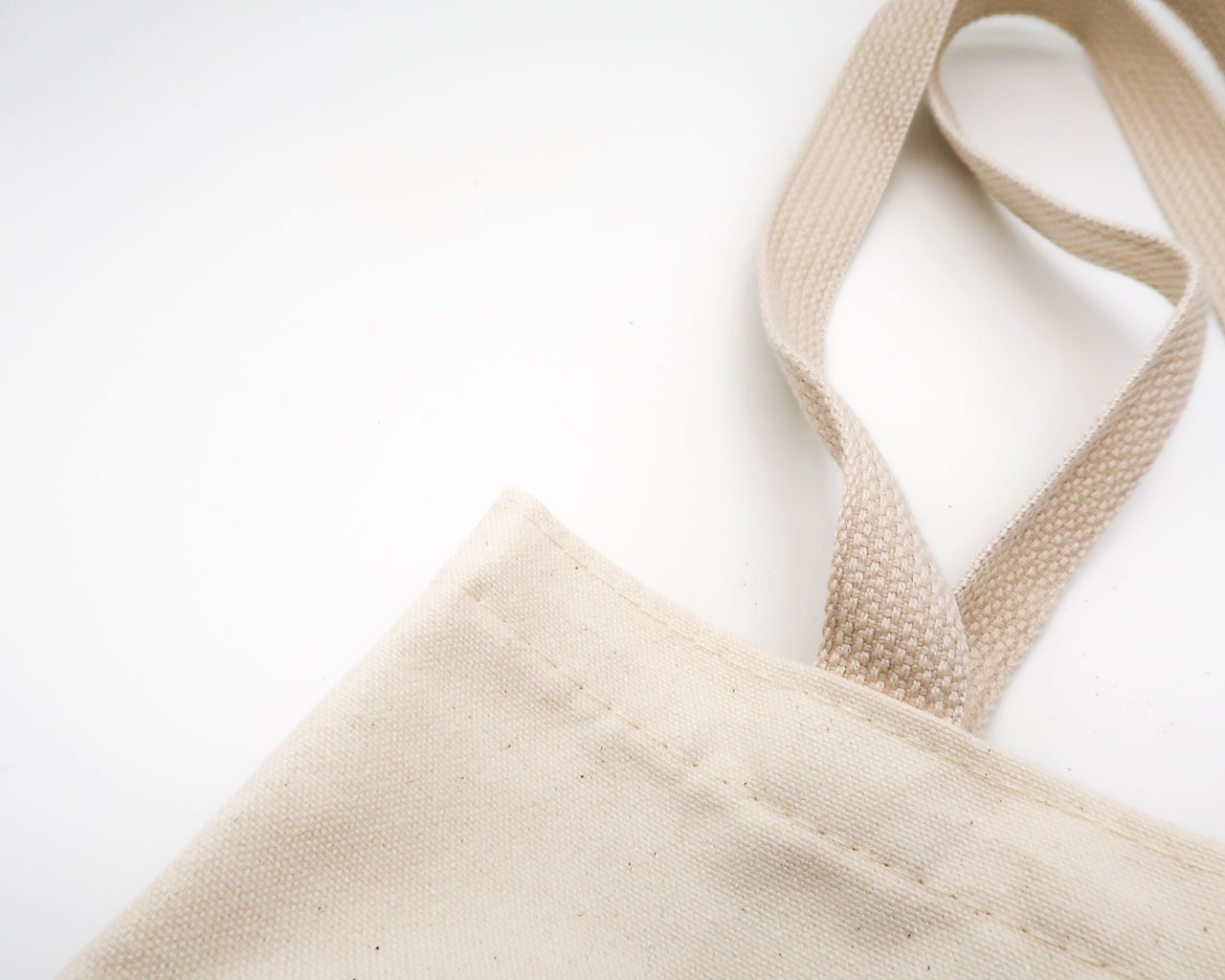 a tan tote bag against a white background