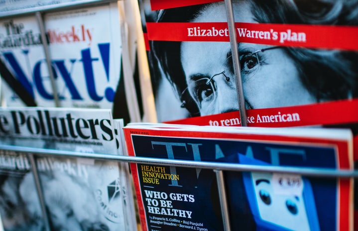 News magazine covers on a rack, including Time and The Economist