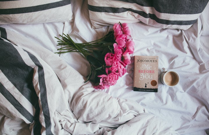 flowers and book on bed