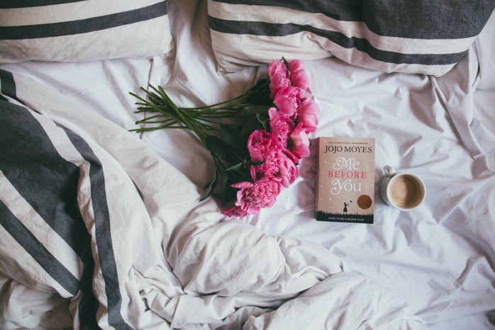 flowers and book on bed