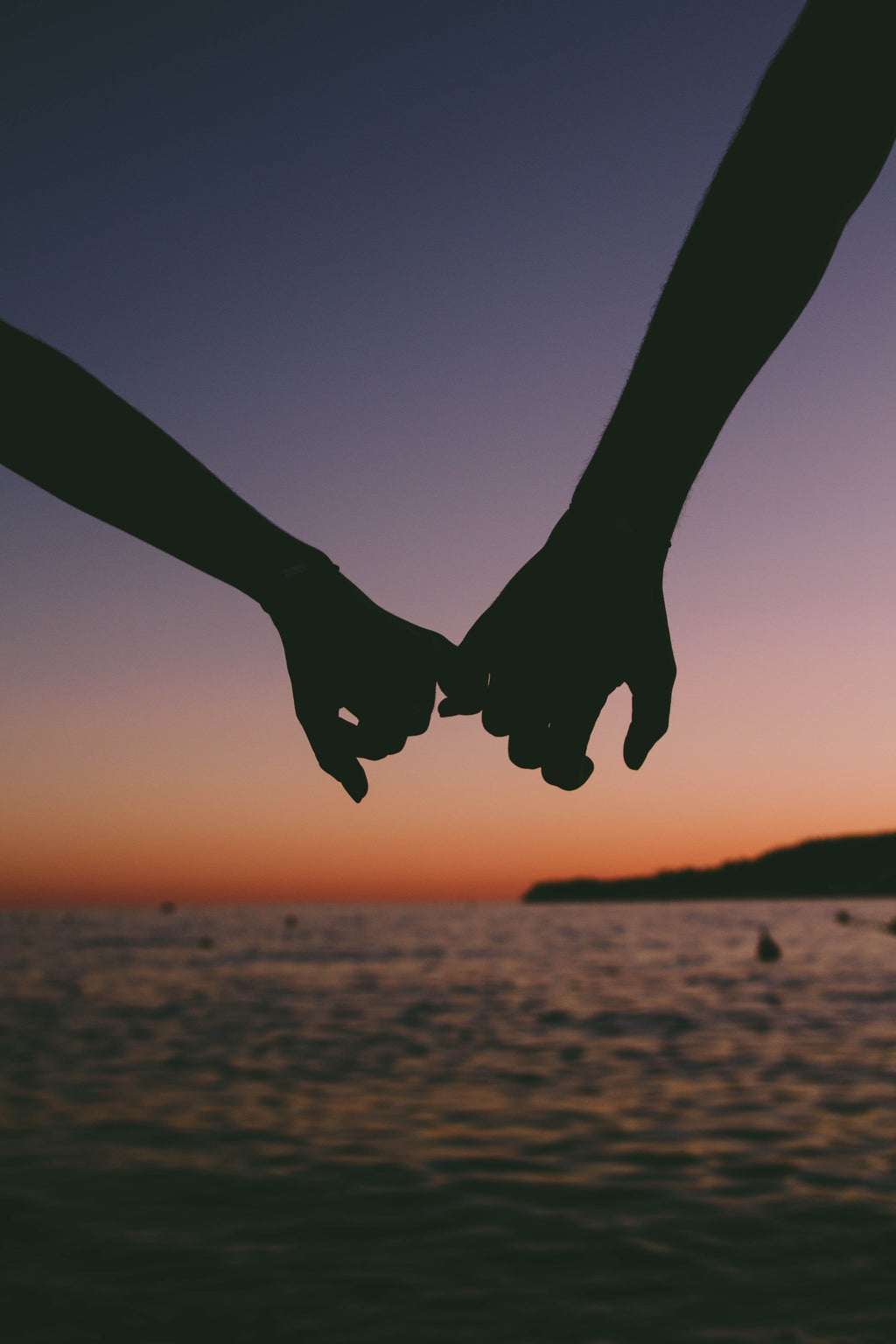 holding hands at sunset