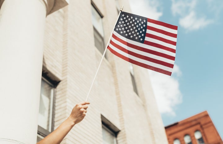 Waving a small flag in front of a building