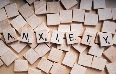 A photo of scrabble words assembled to spell \"anxiety\"