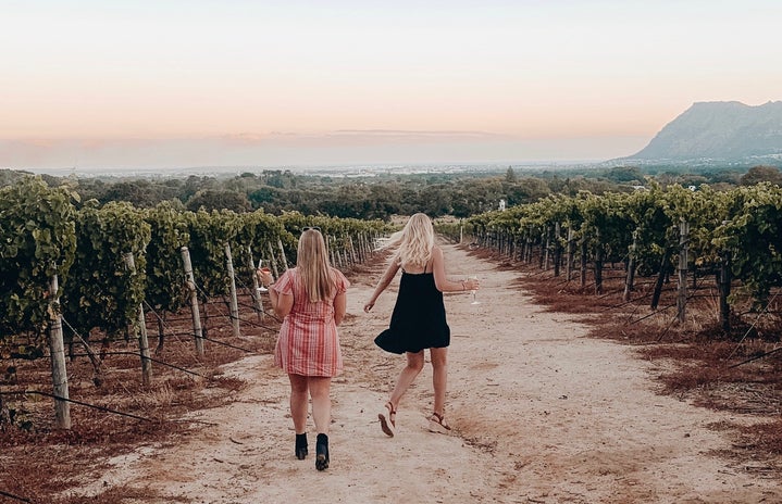 dancing through a wine vineyard in south africa