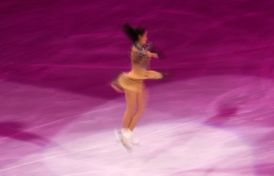 a figure skater performing a triple jump on ice