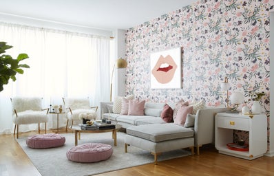 a living room heavy in white, pink and green colors.