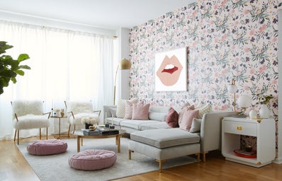 a living room heavy in white, pink and green colors.
